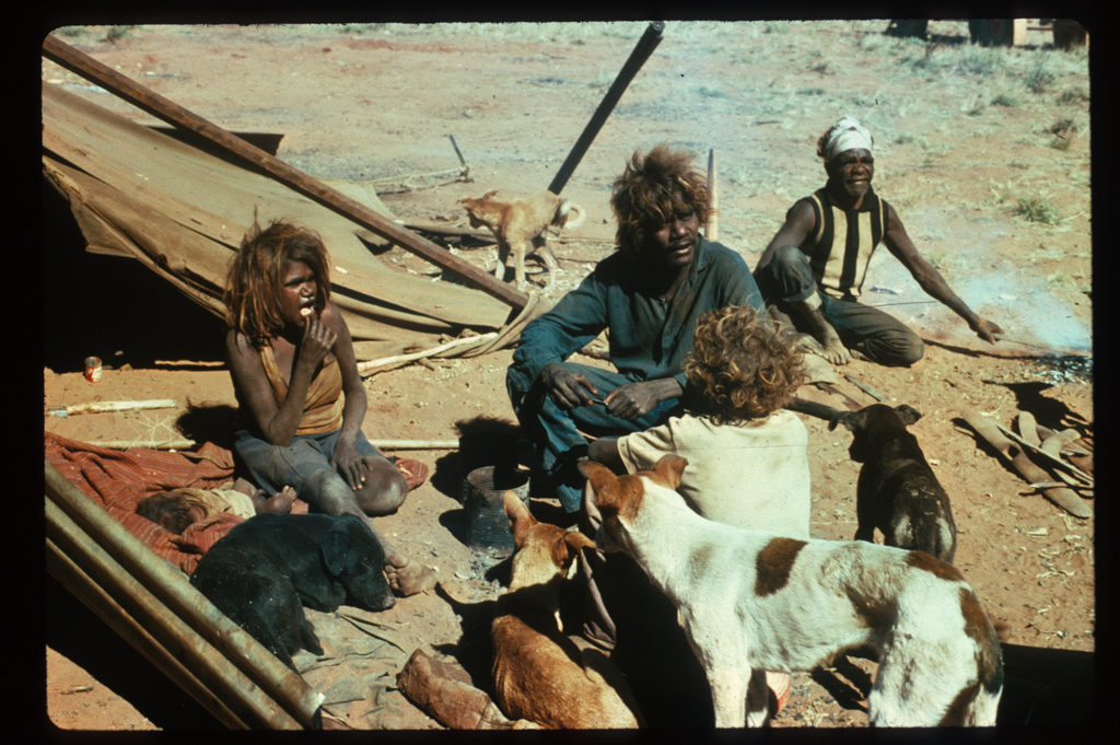 Anatjari Tjampitjinpa at Yayayi in 1974 with his daughter, son and nephew.  Photo Credit Es Giddy    